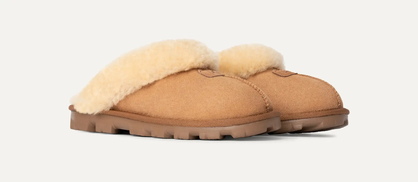 Pair of tan Ugg slippers with white fur lining perfect for dorm and even for class