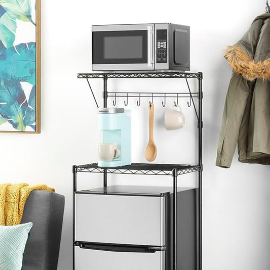 Black metal dorm kitchen rack holding a microwave, coffee maker, mugs, and mini fridge.
