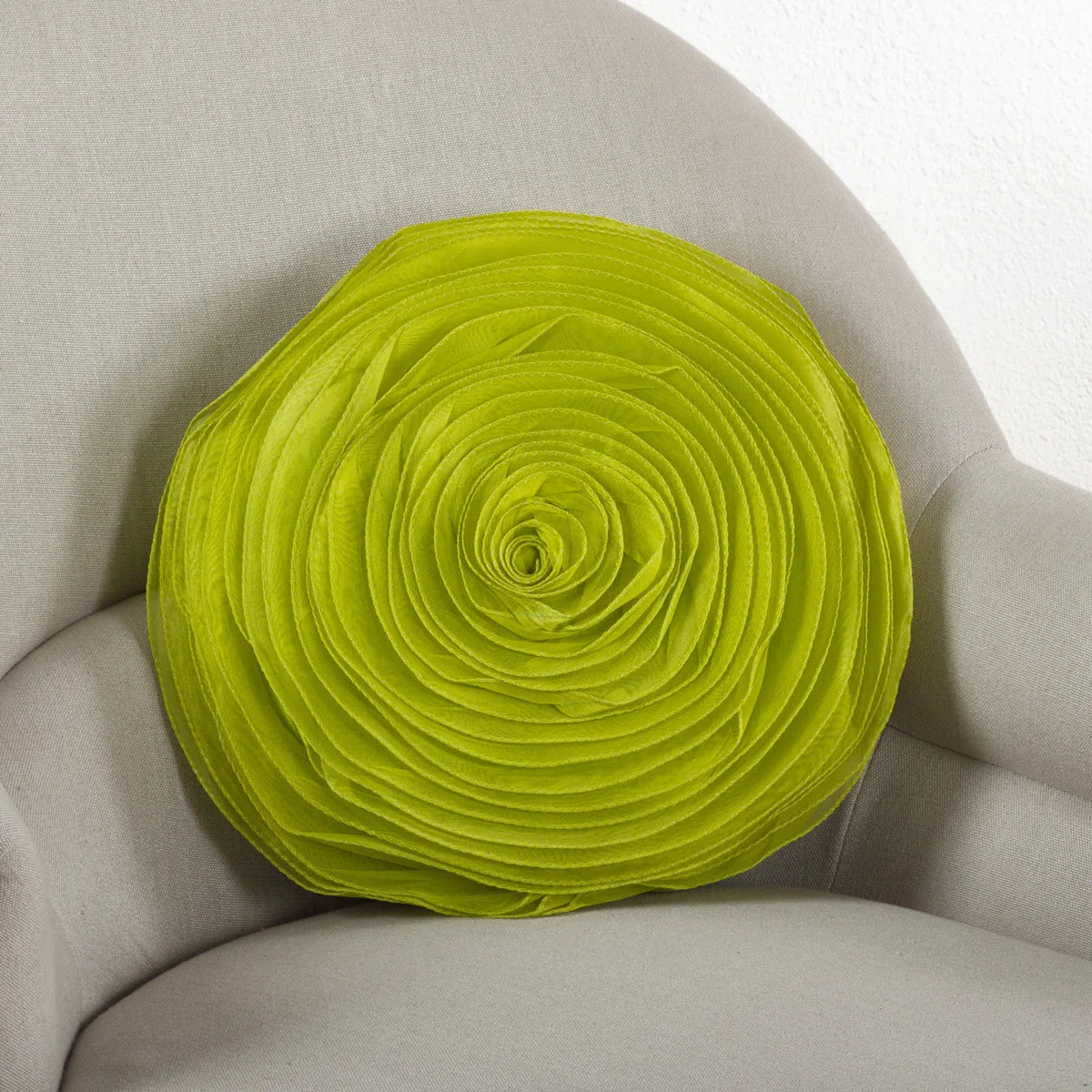 Round lime rose throw pillow with layered satin petals on a cream armchair, perfect for glam or coquette dorm décor